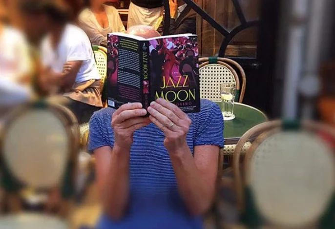A fan reading Jazz Moon at an outdoor cafe in Paris. Photo by Richard Stabbert.