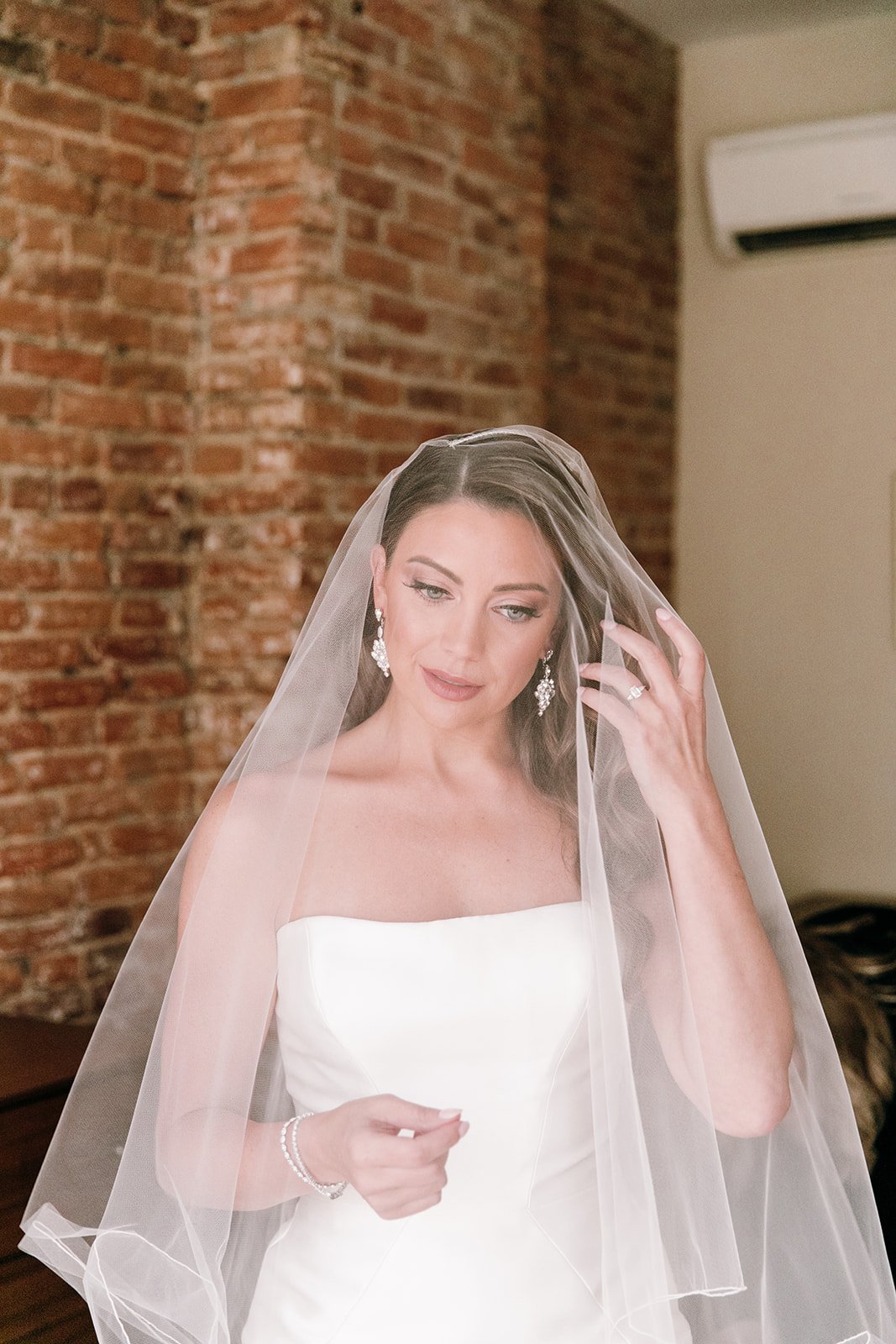bride in gown with veil over her face