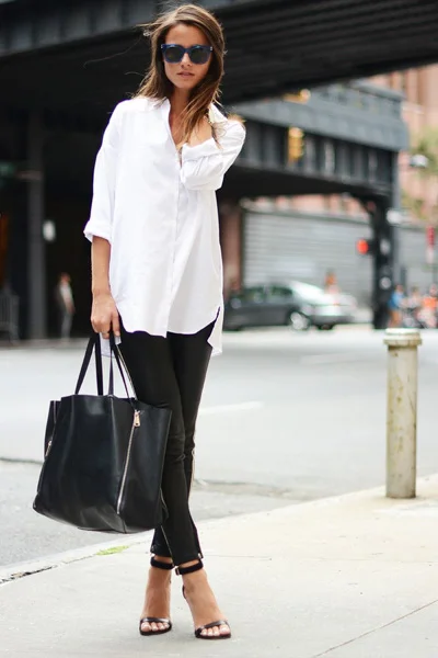 White tunic shirt and black leather pants with black bag and shoes for a simple street style