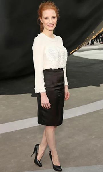 White ruffled blouse with black pencil skirt