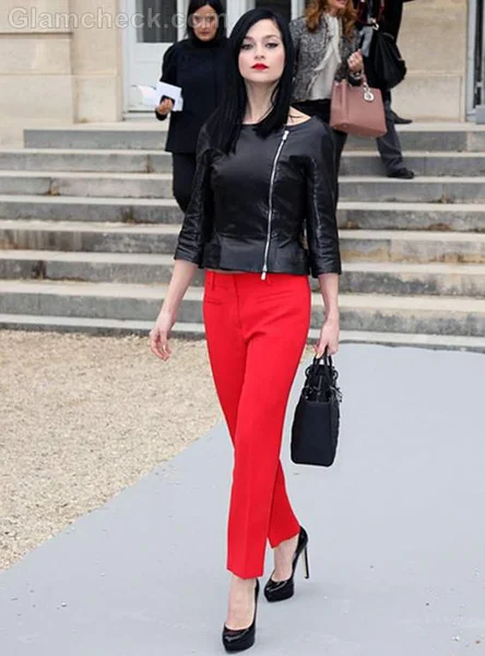 Black leather top pairs with tailored red pants and shiny black pumps