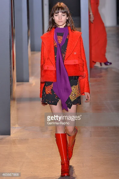 Orange jacket and boots with purple scarf