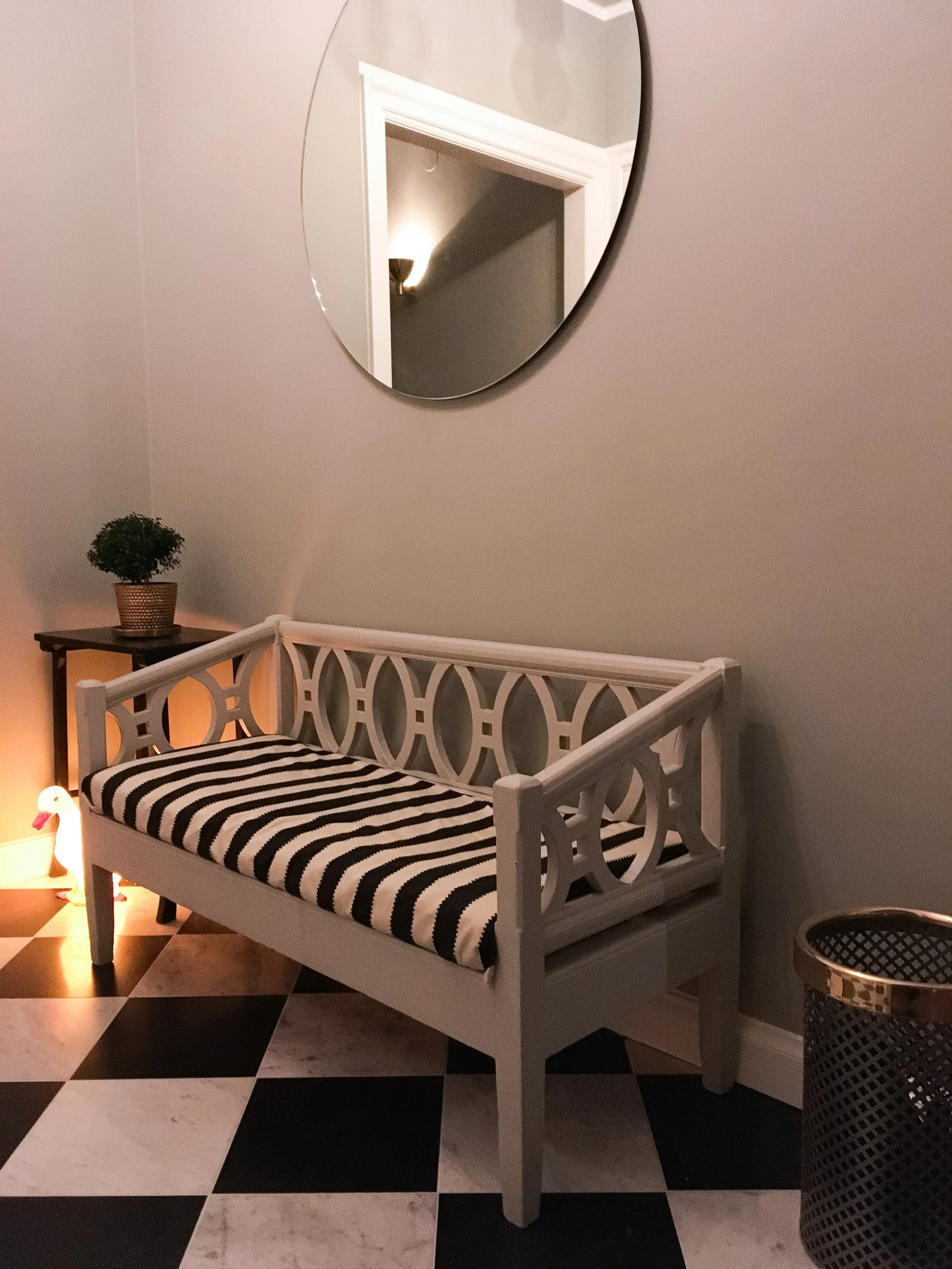 The hallway has a monochrome feel with all black, white and gray, with brass details. I really love the checkered marble floor.