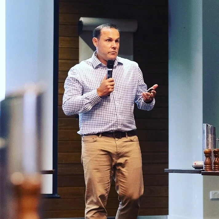 Leader speaking to a group of business owners