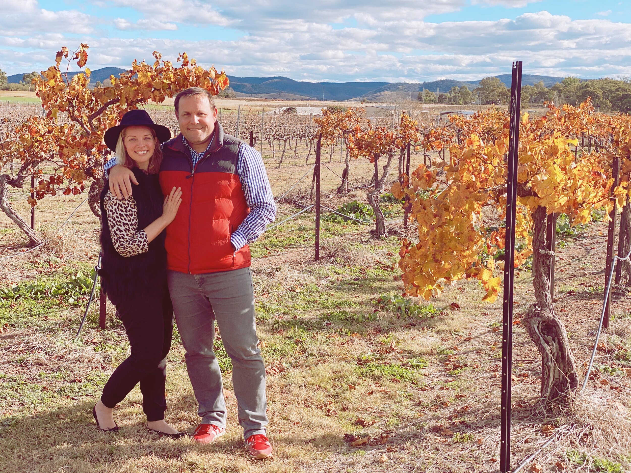 Two people standing in a vinyard