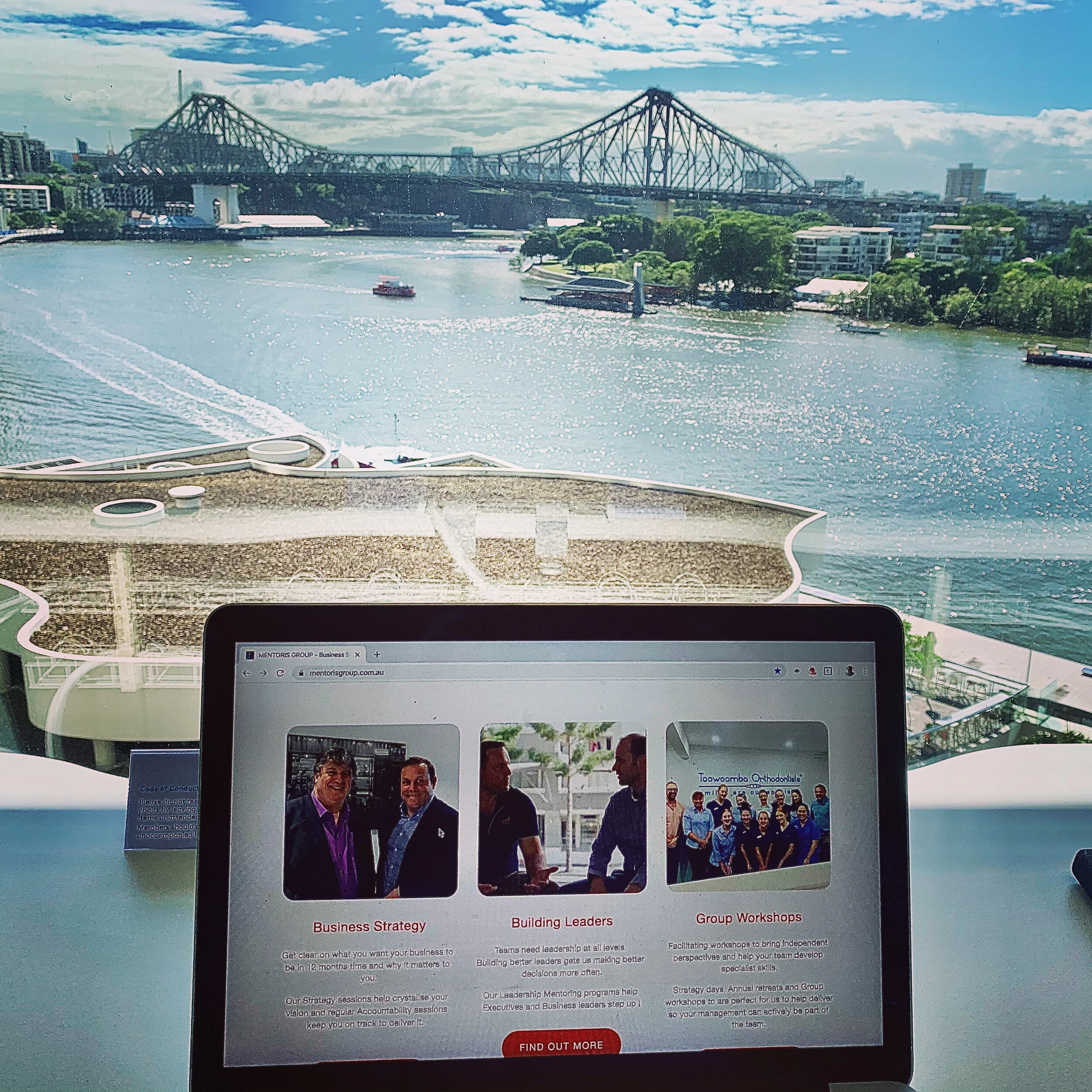 Laptop in front of a bridge