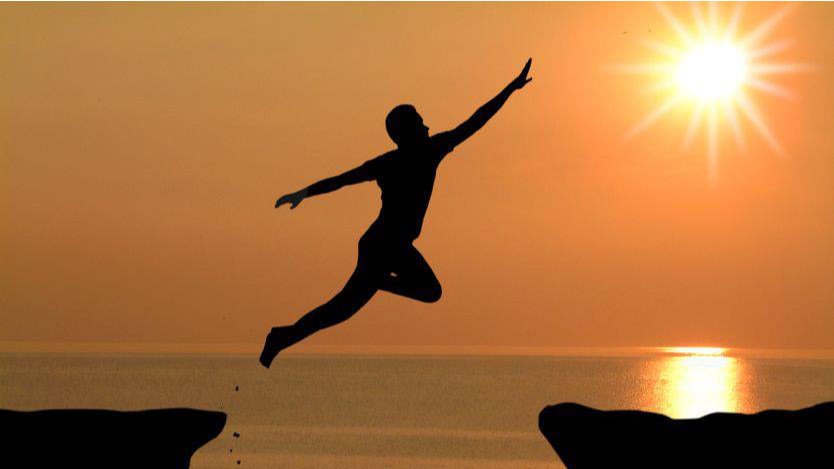 Person jumping towards the sun