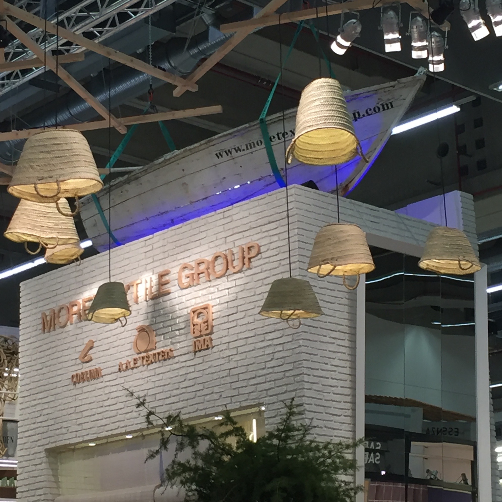 Straw totes as pendant lights -- and a boat on top of the booth!