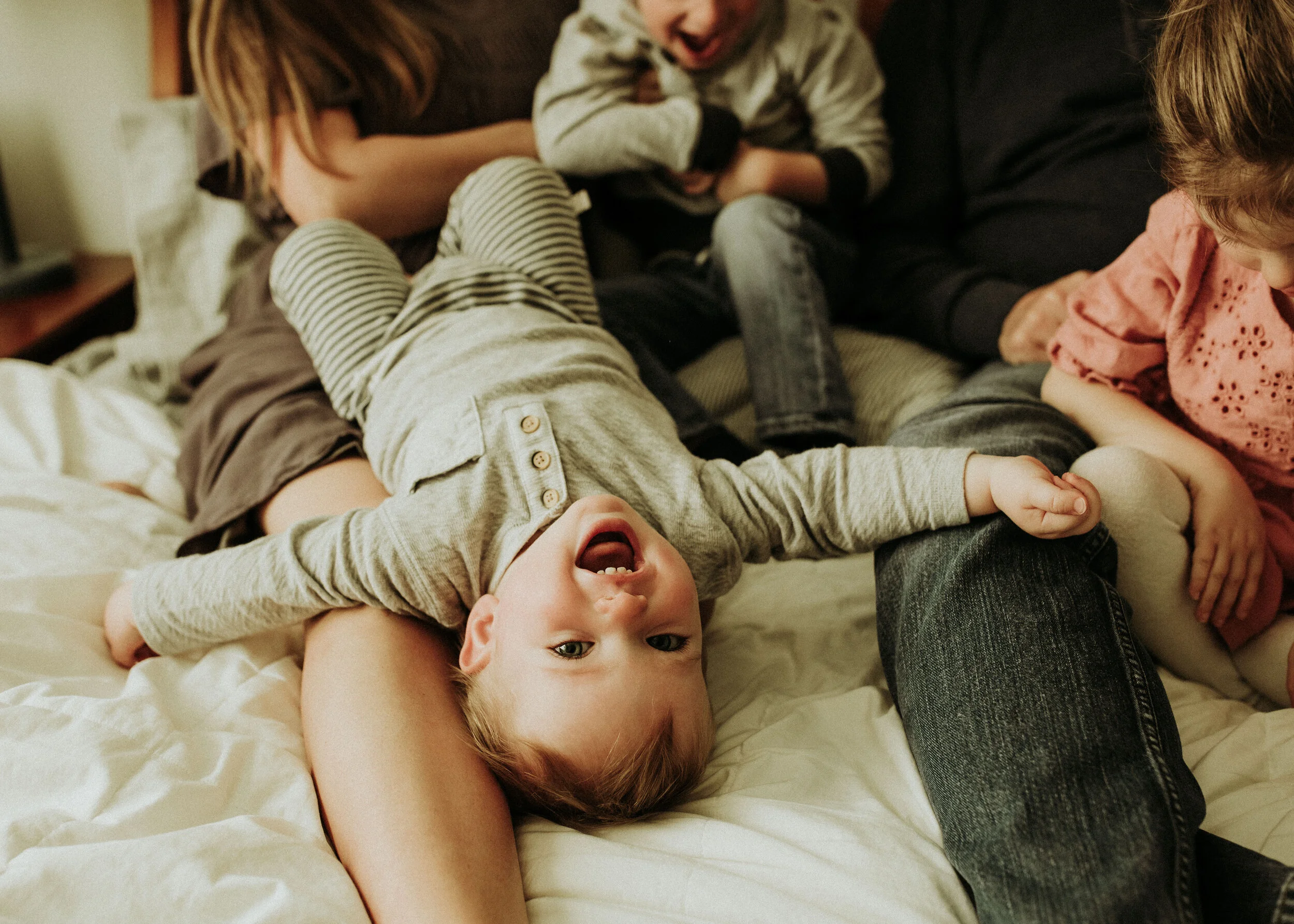 In-home session with a tickle fight on mom and dad’s bed!