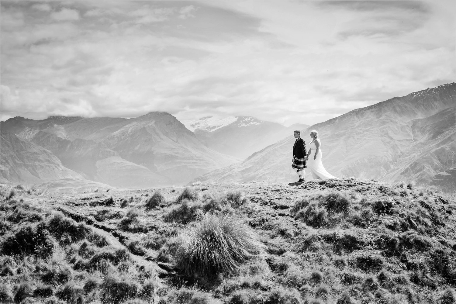 Black and White Portrait of newly married couple walking along Coromandel Peak in New Zealand