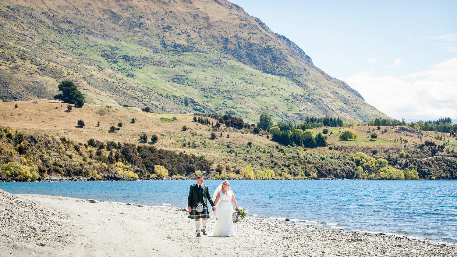 Married couple walks along south shore of Lake Wanaka