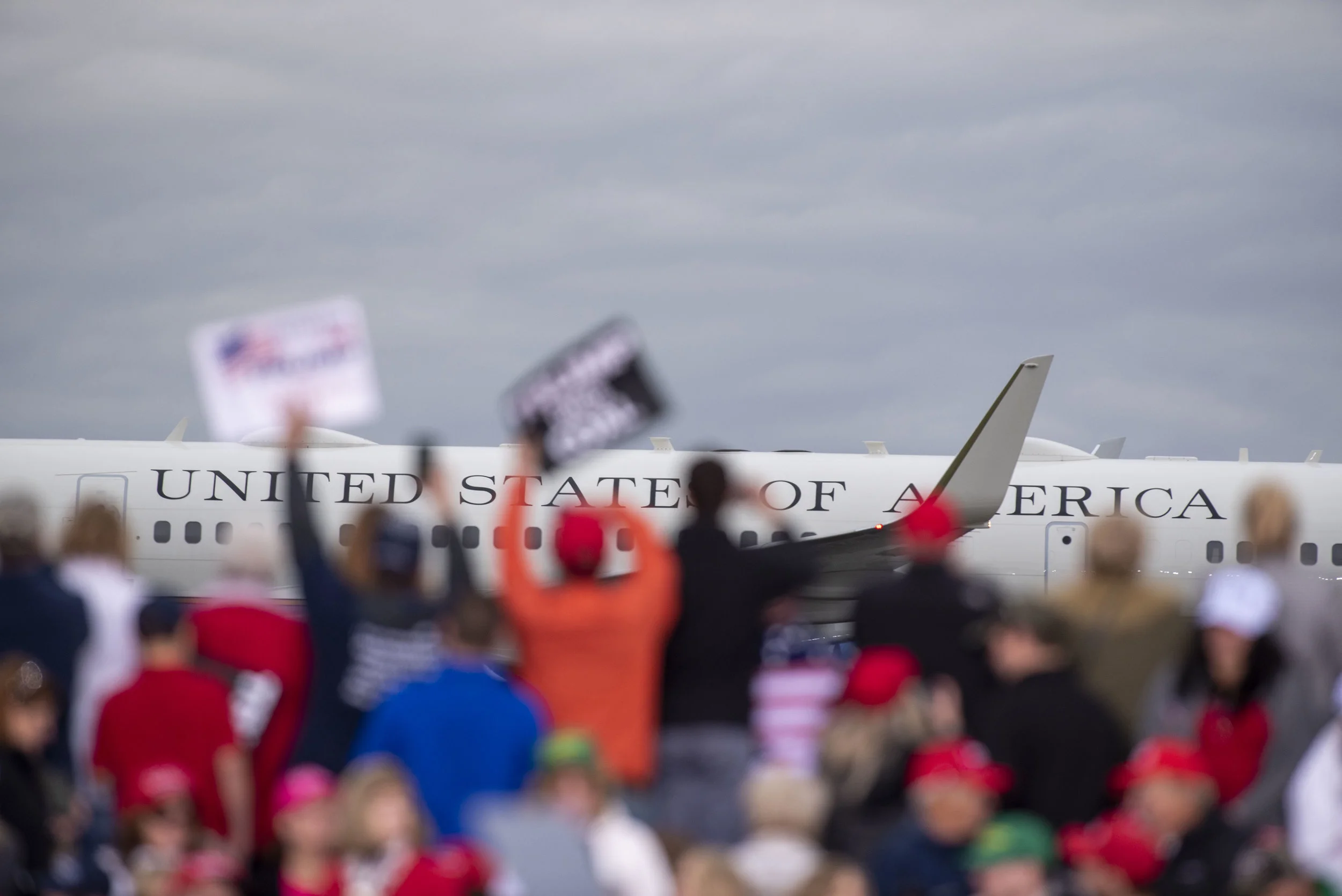 Supporters of President Donald Trump cheer as Air Force One arrives in Huntington, WV prior to a campaign rally.