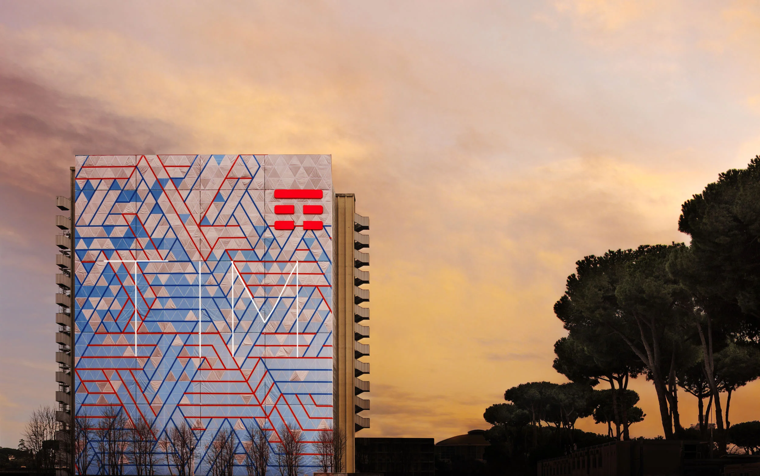 TIM is the Italian telecomunication company. This is going to be its headquarter in Rome. TIM reflects ideas, thoughts and emotions around the globe. It is like a huge intangible interconnected mirror. A custom iridescent textile has been designed and produced to dematerialize the towers from the skyline of EUR in Rome. Curator: Caroline Corbetta - Artist: Matteo Cibic - Agency: Havas Worldwide
