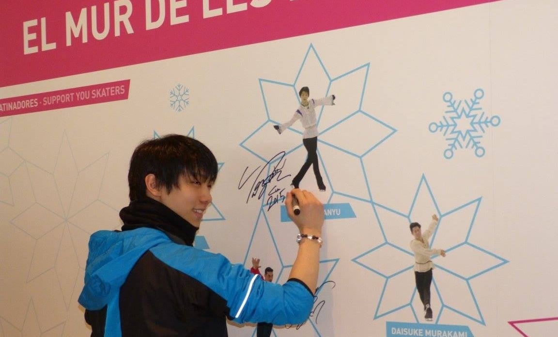 Yuzuru Hanyu signs his picture on the "Wall of Stars" at December's Grand Prix Final. (ISU photo)