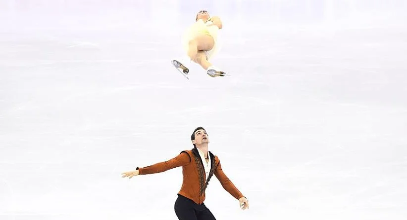 Chris Knierim sends partner Alexa Scimeca airborne at the Grand Prix final, where the couple had three falls in the free skate. (ISU photo)