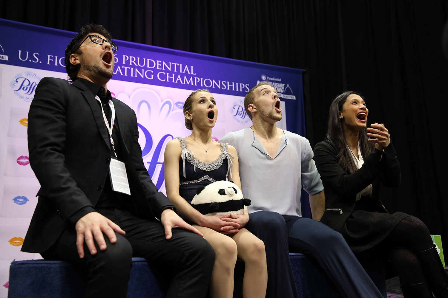 Skaters Tarah Kayne (with stuffed animal) and Daniel O'Shea and their coaches Jim Peterson (far left) and Amanda Evora, react with shock and delight over their personal-best score in the pairs free skate. (U.S. Figure Skating / Jay Adeff) 