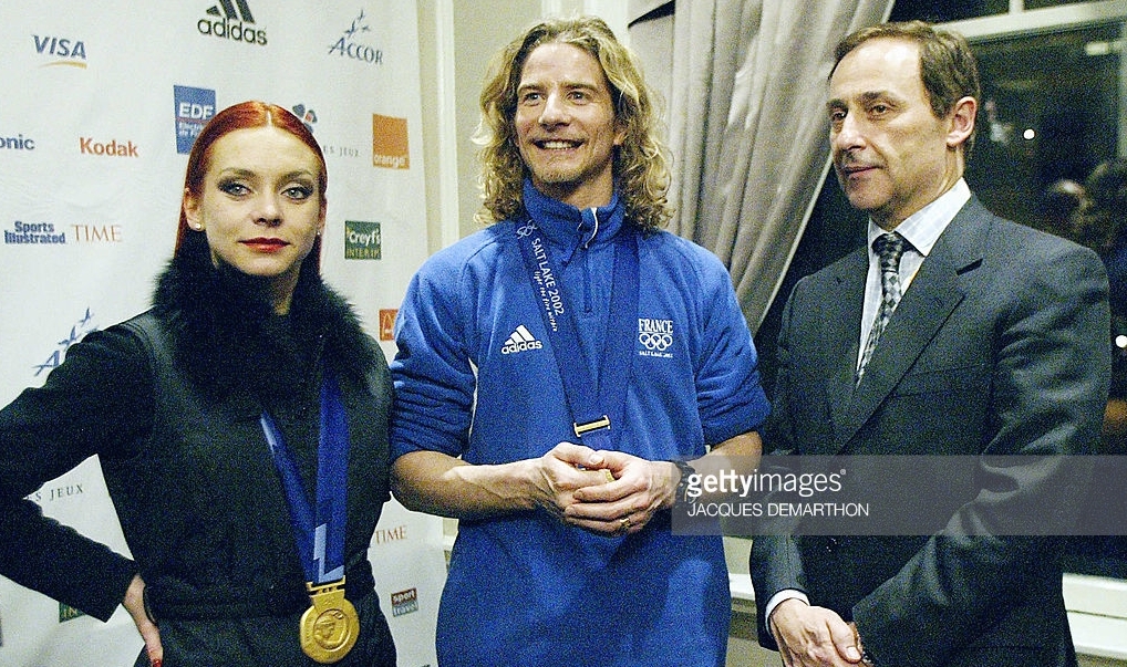 France's Didier Gailhaguet with French ice dance gold medalists Marina Anissina and Gwendal Peizerat at the 2002 Olympics, where Gailhaguet's involvement in influencing the dance and pairs results led to his three-year suspension from international skating.
