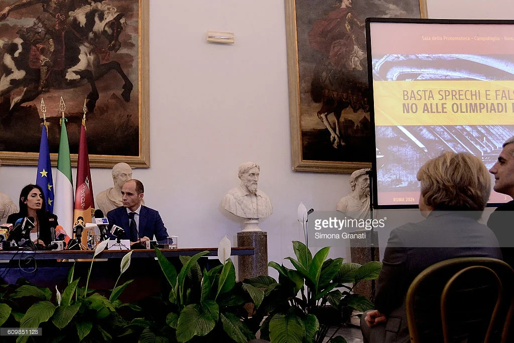 Rome mayor Virginia Raggi (far left) officially rejecting the city's 2024 Olympic bid, with the sign saying, "Enough waste...no to the Olympics."