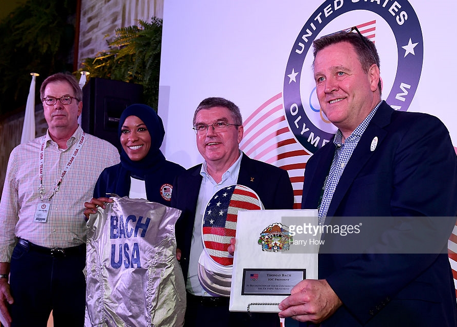 Muslim-American Olympic fencer Ibtihaj Muhammad joined, from left, USOC chairman Larry Probst, IOC President Thomas Bach and USOC chief executive Scott Blackmun in a gift presentation to Bach at the Rio Olympics. Muhammad's presence now looks like window dressing in the light of the USOC's anodyne statement about president Trump's Muslim-targeted immigration and travel ban.