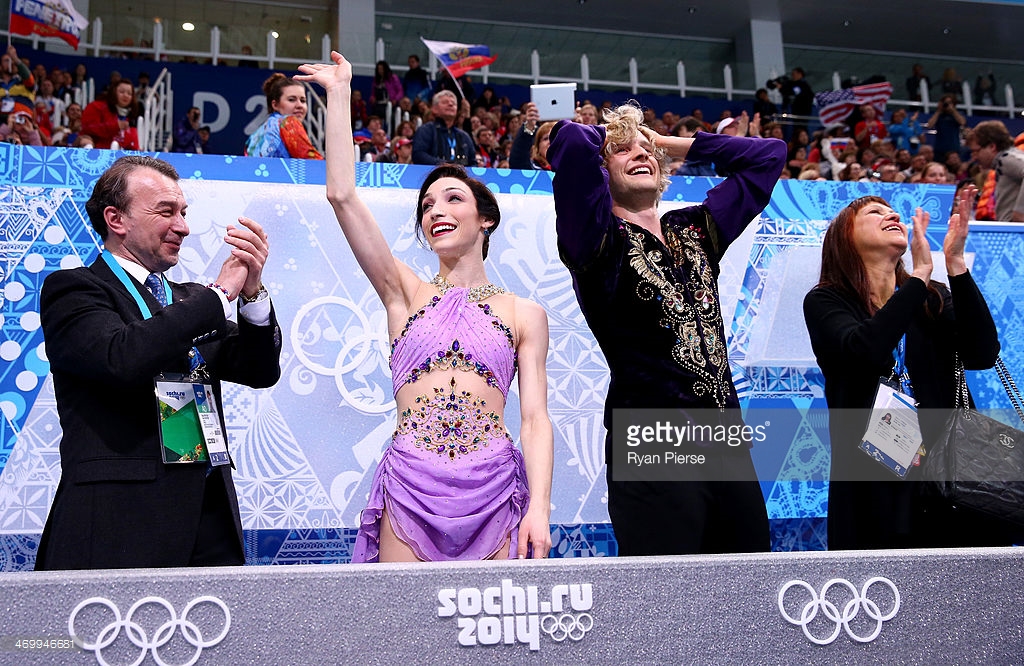 Coaches Oleg Epstein (far left) and Marina Zoueva (far right) applaud U.S. ice dancers Meryl Davis and Charlie White as they received the winning scores at the 2014 Olympics. (Getty Images)