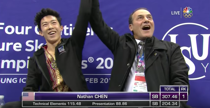 Like a referee in a boxing ring, coach Rafael Arutunian raises Nathan Chen's arm to signify the sport's new champion heavyweight. 