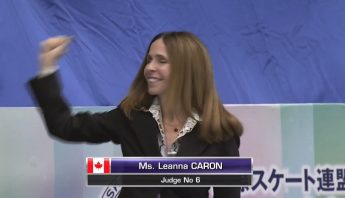 TV screenshot of Leanna Caron as judges announced to crowd at the 2016 NHK Trophy Grand Prix event.