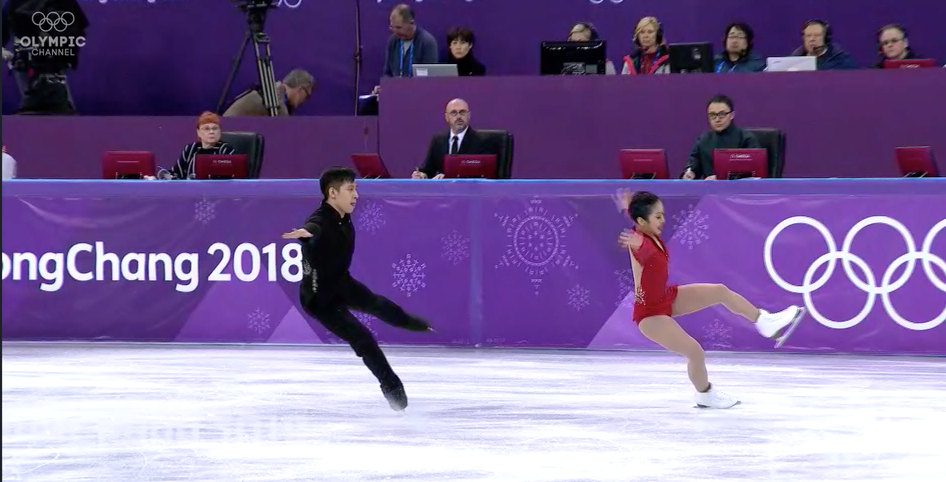 A Chinese judge was suspended for bias that led him to overlook mistakes like this botched landing by Chinese pair Sui Wenjing and Han Cong and place them first in the Olympic free skate. (Screenshot from the Olympic Channel.)