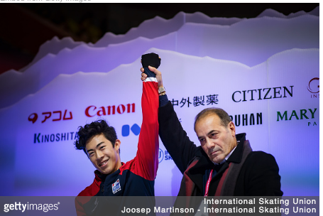 Like a manager saluting a boxing champ, coach Rafael Arutunian raises Nathan Chen’s arm in triumph.