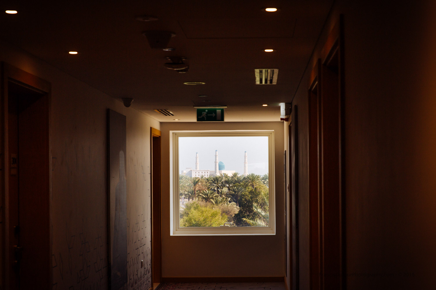 Like a luminous painting hanged on the wall, the Sultan Qaboos Mosque seen from a corridor ar Mercure Hotel (Sohar, Oman).