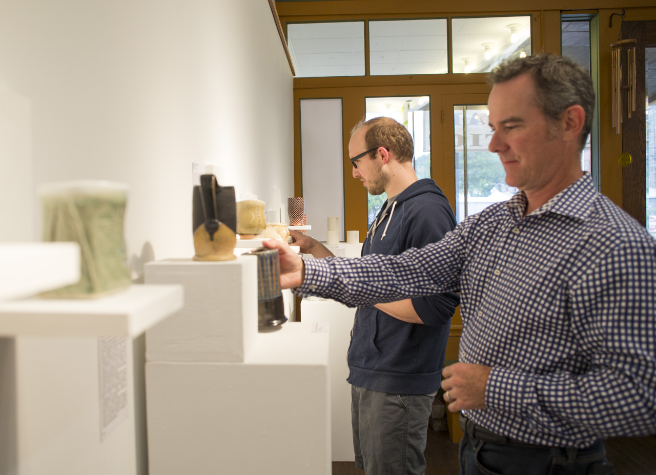  Brett Kern, back, an artist from Elkins, WV and a participant in the Starbrick Clay National Cup Show, looks at other artists’ cups with David Hiltner, front, of Red Lodge, MT and the juror of the show at Starbrick Gallery in Nelsonville, Ohio on Se