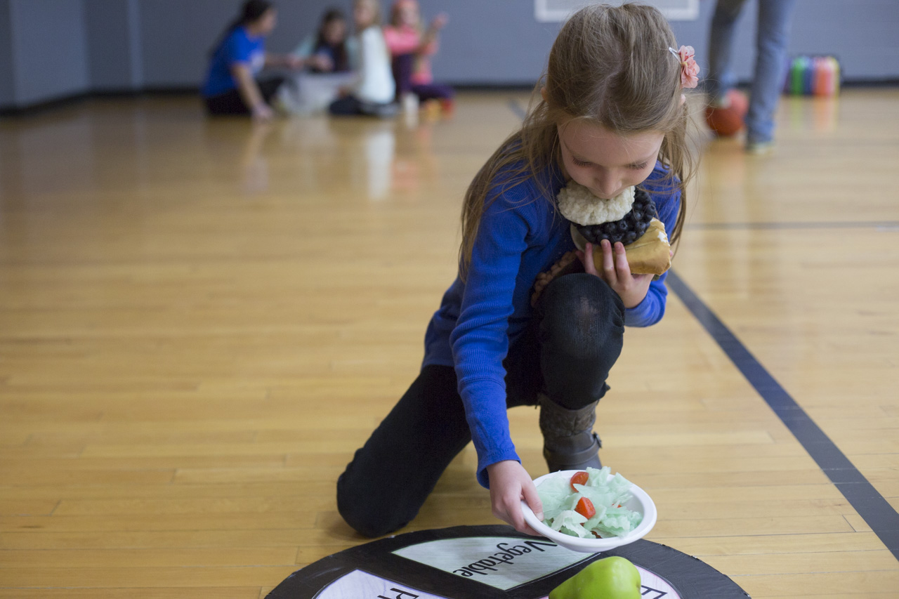  Ellie Cook, 6, the daughter of Karie Cook of Lancaster, Ohio, participates in a relay race that features MyPlate at the Diabetes Expo in the Athens Community Center on November 14, 2015. 