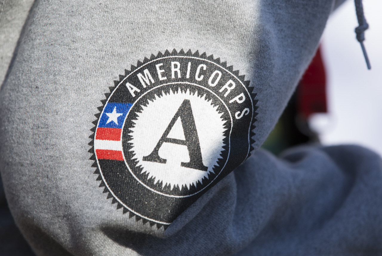  Sarah Pol, an Athens resident and the COMCorps Capacity Building Coordinator, wears the AmeriCorps logo on her sleeve at the Pumpkin Hustle in Athens, Ohio, on November 15, 2015. COMCorps in an AmeriCorps program, making the two closely related. 