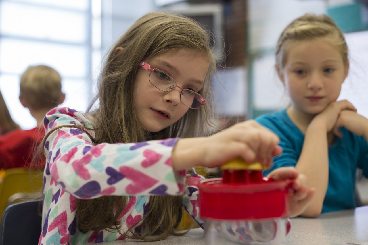  Second-grader Melody Christiansen juices a lemon while her classmate Jesse Vaughn watches during a Live Healthy Kids workshop at West Elementary School in Athens, Ohio, on November 13, 2015. 