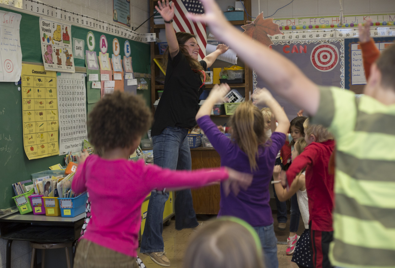  Kerrigan Boyd, a Community Food Initiatives COMCorps member, does jumping jacks with Mr. Rife's second grade class at West Elementary School in Athens, Ohio, after they prepared ingredients for a quinoa recipe during a Live Healthy Kids Workshop on 