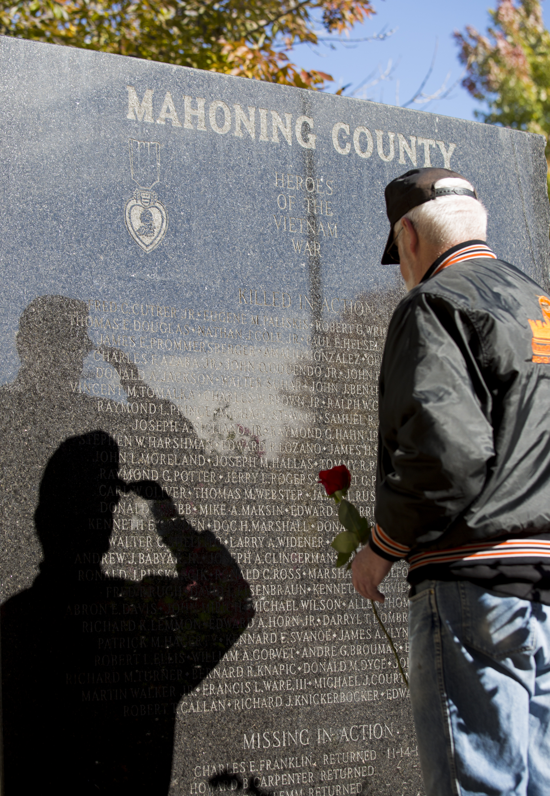  A veteran casts a shadow on the Vietnam Veterans Memorial in Youngstown, Ohio as he salutes before placing a rose at the foot of the memorial during the annual Laying of the Roses ceremony to honor Mahoning County-native fallen soldiers of the Vietn