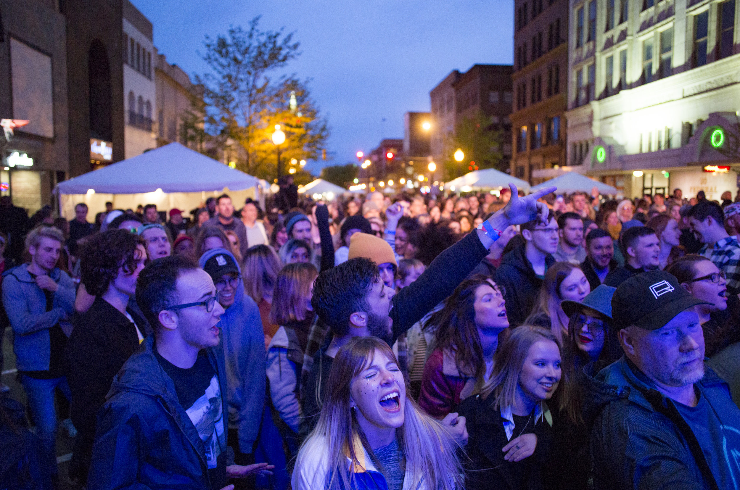  Alison Green, front center, of Boardman, Ohio, sings along as she and the crowd watch and listen to Spirit of the Bear perform at Federal Frenzy in downtown Youngstown, Ohio, on April 27, 2019. 