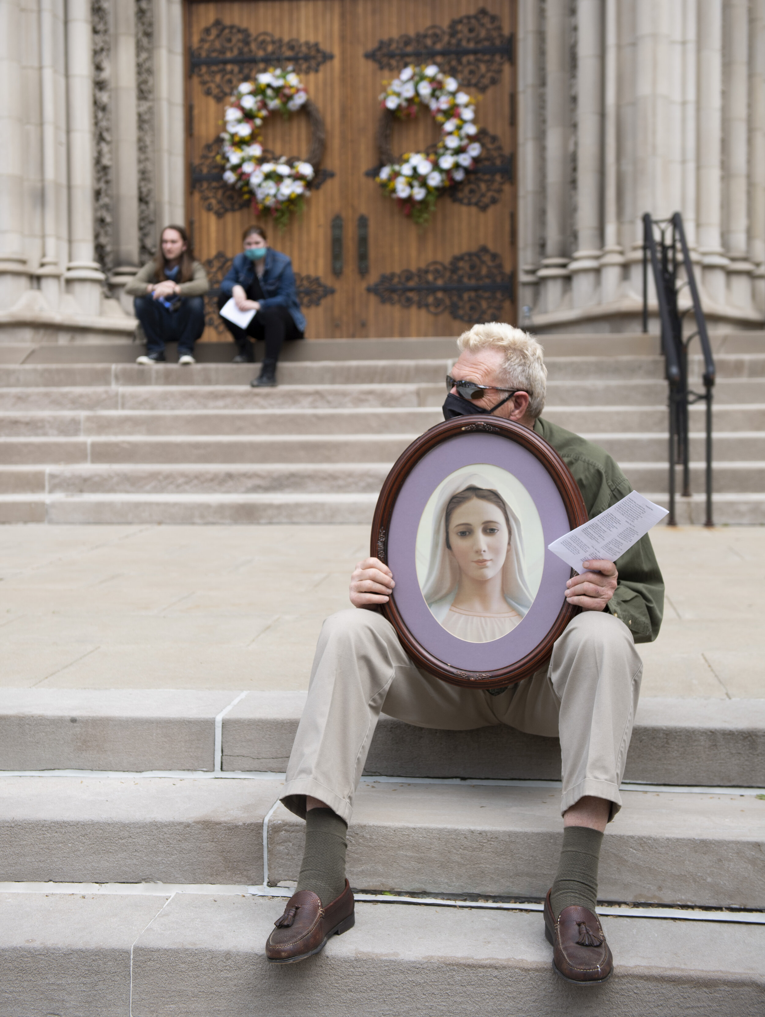  Bob Pacacha, of Bethel Park, holds an image of Mary outside St. Paul Cathedral before the start of the Procession to Restore the Mass on Sunday, May 17, 2020, in Oakland. The purpose of the procession was to call upon God for the quick restoration o