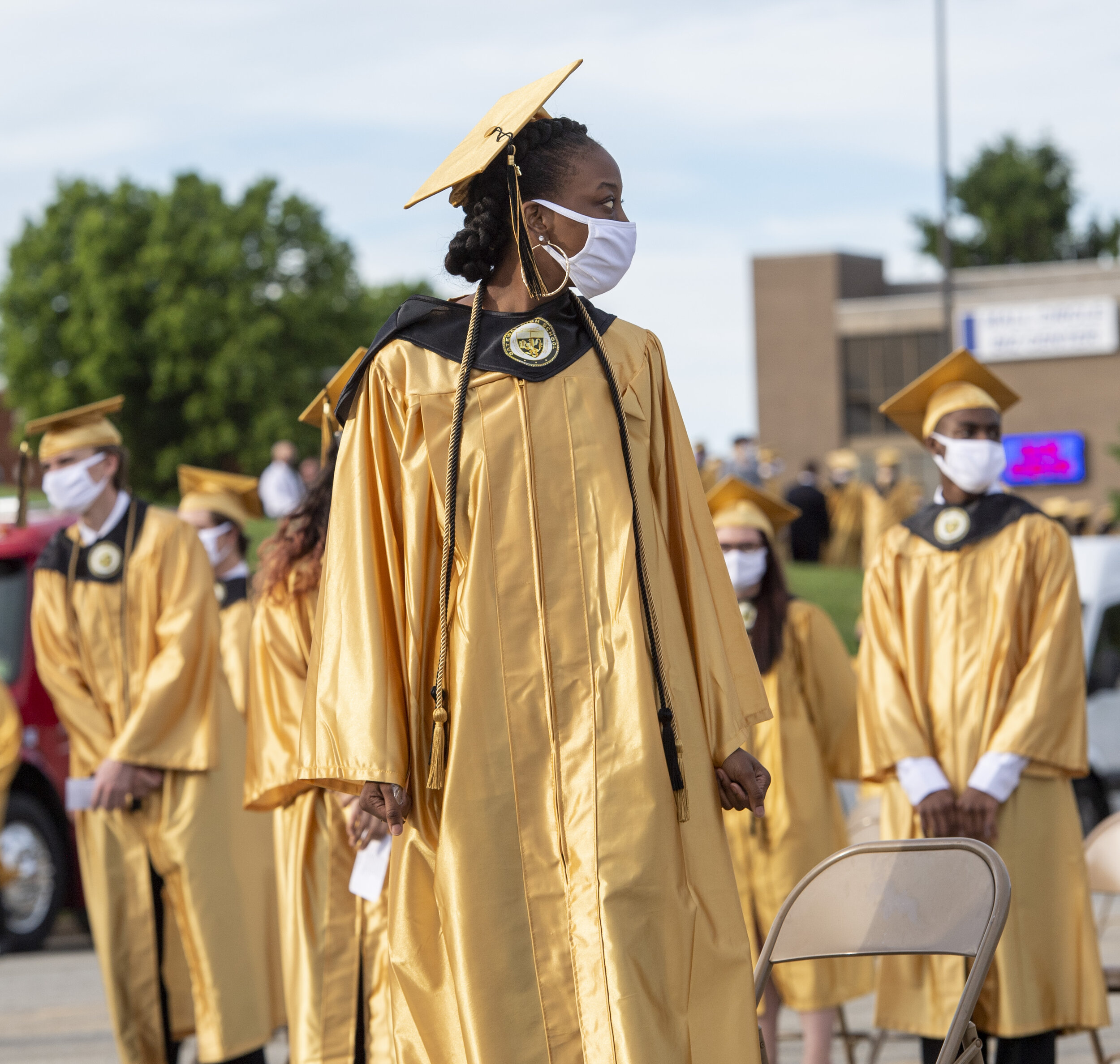  Selasi Agbodzie, a graduating senior at Gateway High School, stands with her classmates while maintaining six feet apart before the beginning of Gateway High School’s graduation ceremony on Wednesday, May 27, 2020, in the Macy’s parking lot at the M