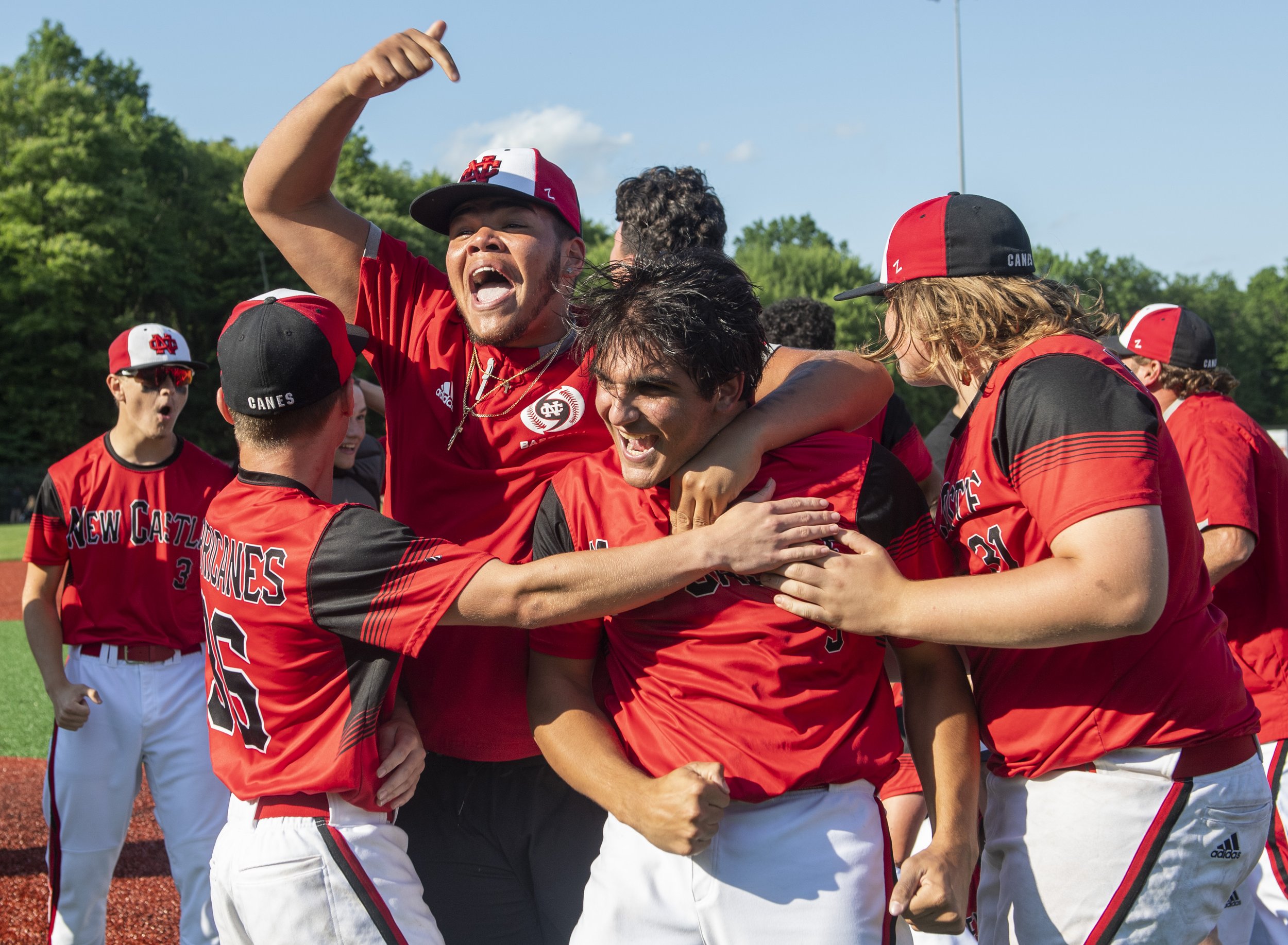  New Castle pitcher Anthony Miller, center, celebrates with his teammates after their 3-1 victory against Montour on Monday, June 14, 2021, at Neshannock High School in New Castle, Pa. (Emily Matthews/Post-Gazette)  