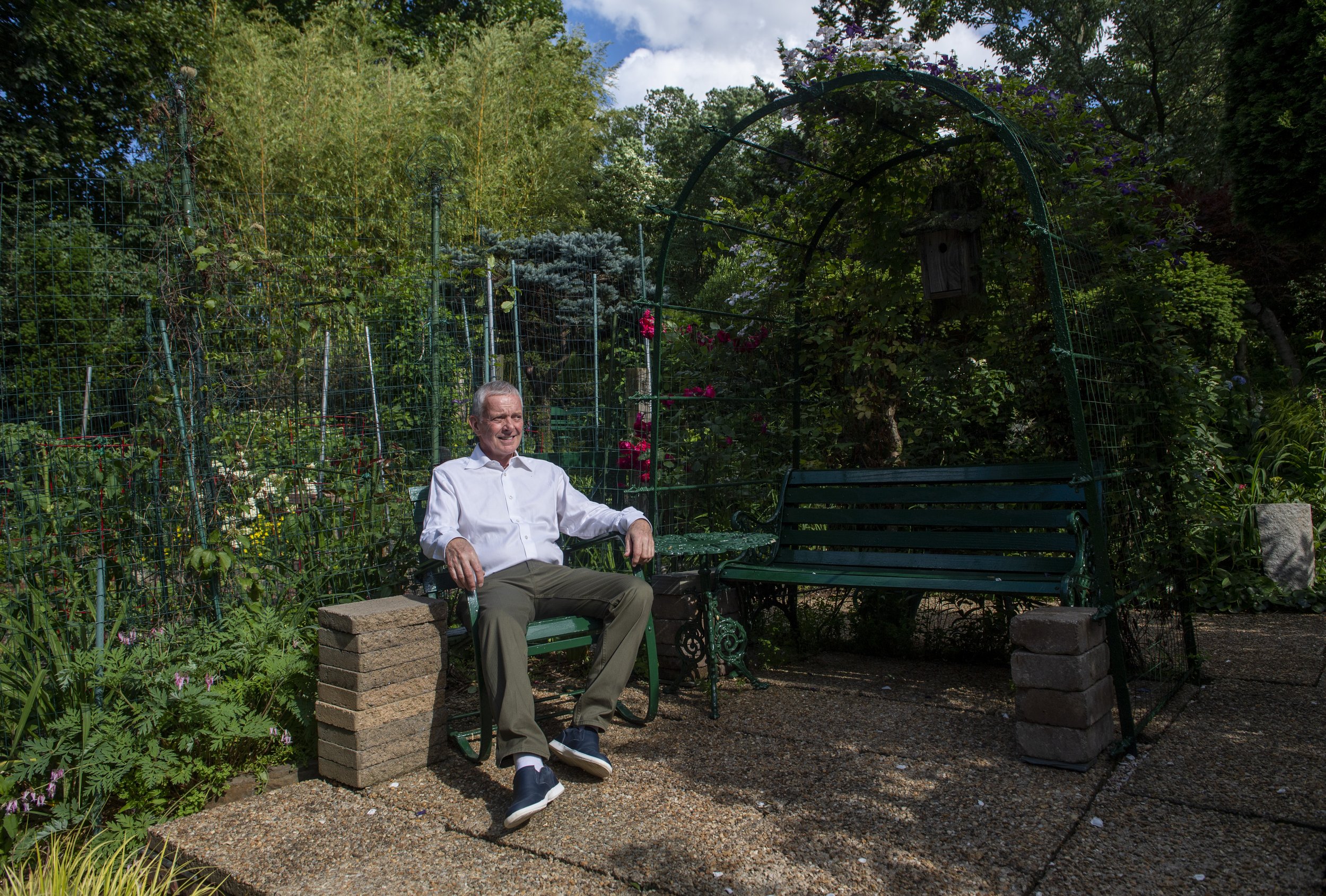  Mark Meaders sits in his garden on Tuesday, June 15, 2021, in Pittsburgh’s Squirrel Hill. Meaders' garden was one of 12 that was featured in the Symphony Splendor Garden Tour on June 27. (Emily Matthews/Post-Gazette) 