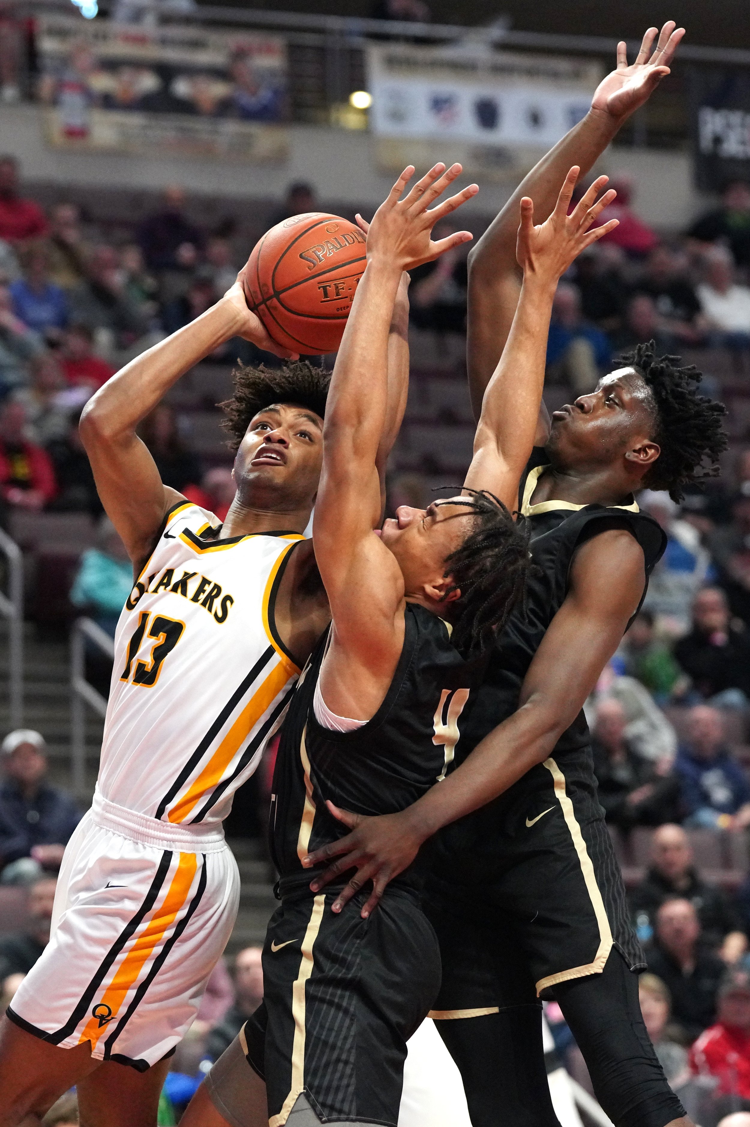  Quaker Valley’s Markus Frank, left, looks to the basket as Neumann-Goretti’s Masud Stewart, middle, and Sultan Adewale try to block him in the PIAA 4A boys basketball championship on Thursday, March 24, 2022, at Giant Center in Hershey, Pa. Quaker V