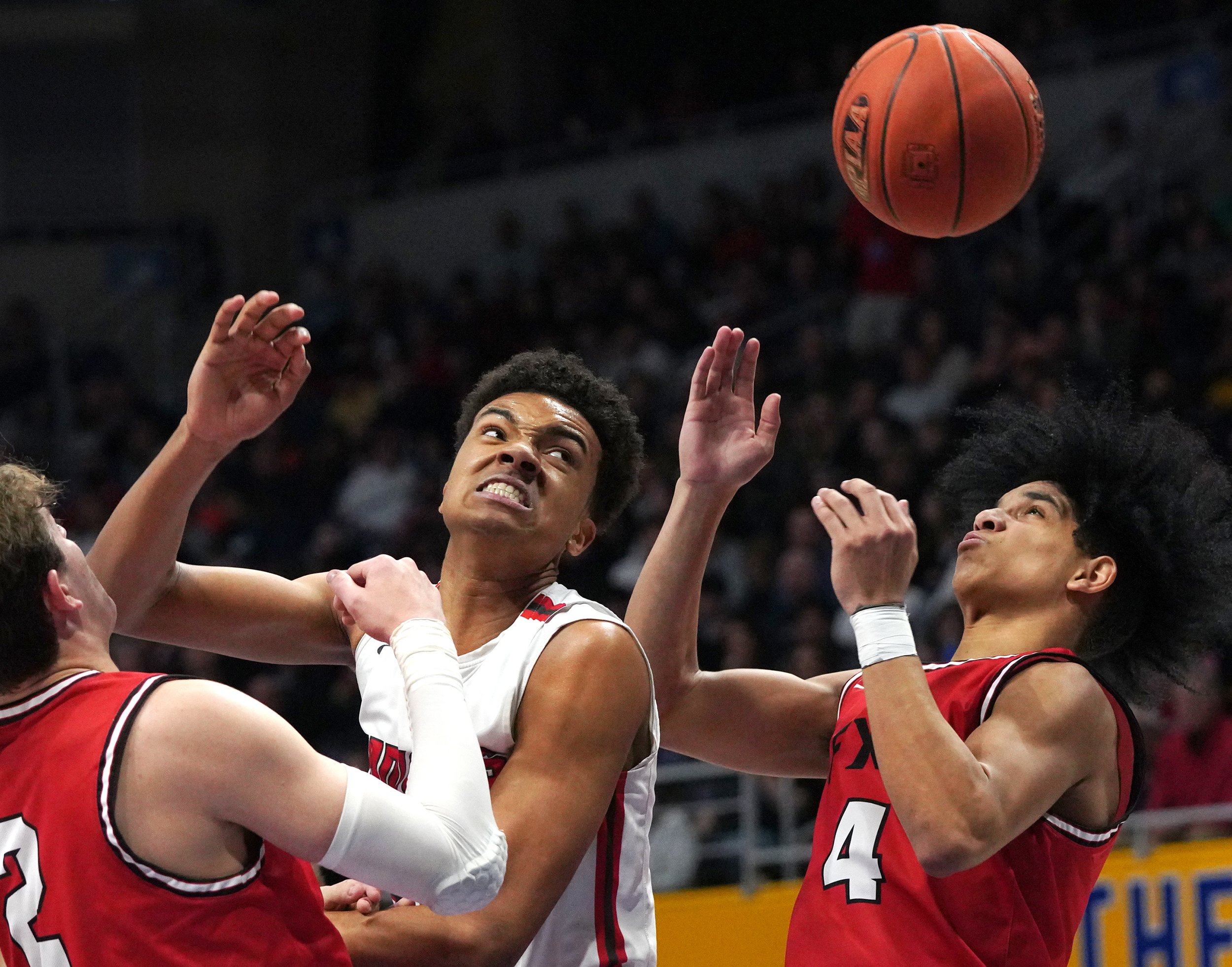  North Hills High School’s Royce Parham and Fox Chapel High School’s Jeff Moorefield-Brown watch a rebound on Saturday, March 5, 2022, at the Petersen Events Center in Pittsburgh’s Oakland. Fox Chapel won 43-36. (Emily Matthews/Post-Gazette)  