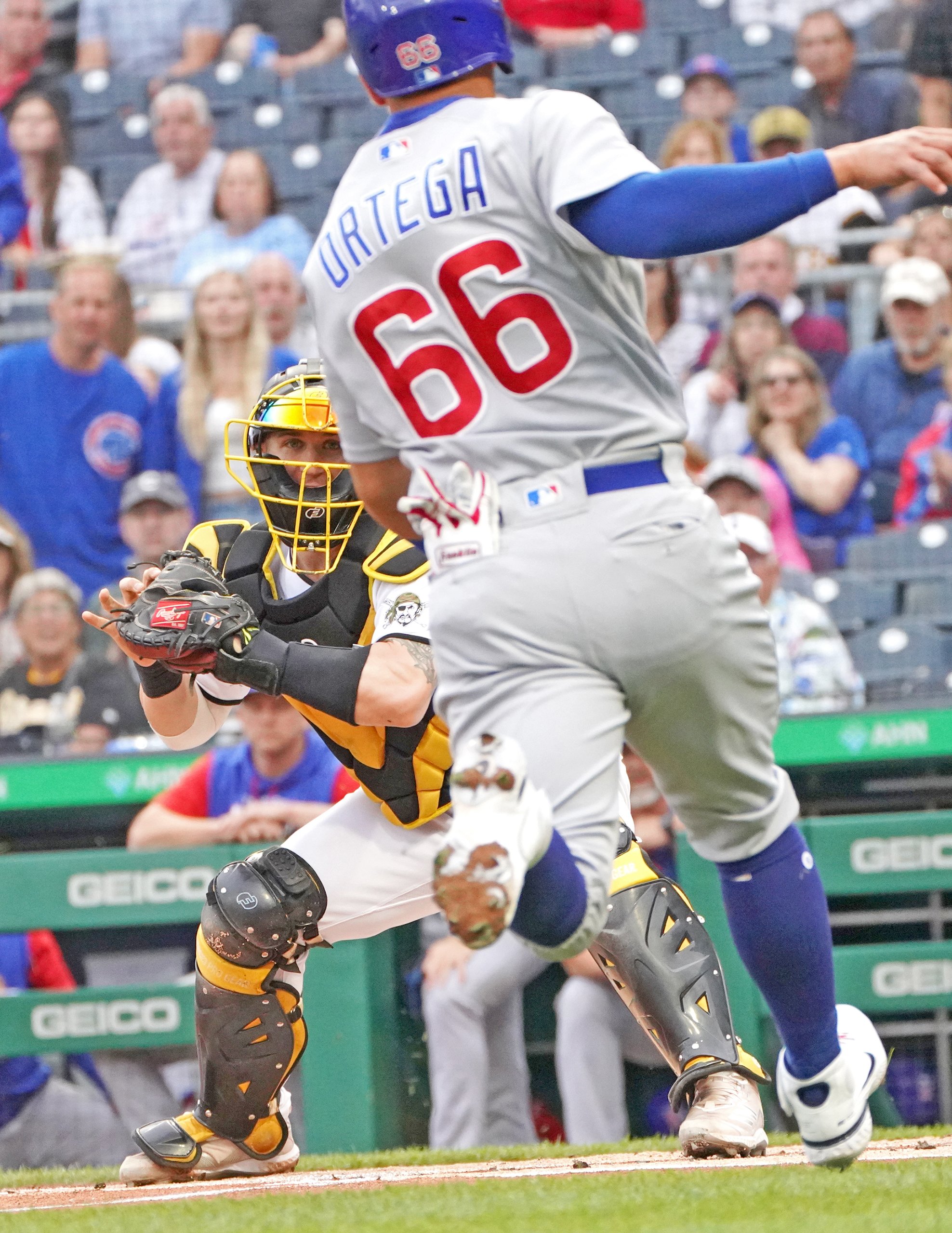  The Pirates’ catcher Tyler Heineman prepares to tag the Cubs’ Rafael Ortegal out at home on Monday, June 20, 2022, at PNC Park . The Pirates won 12-1. (Emily Matthews/Post-Gazette)  