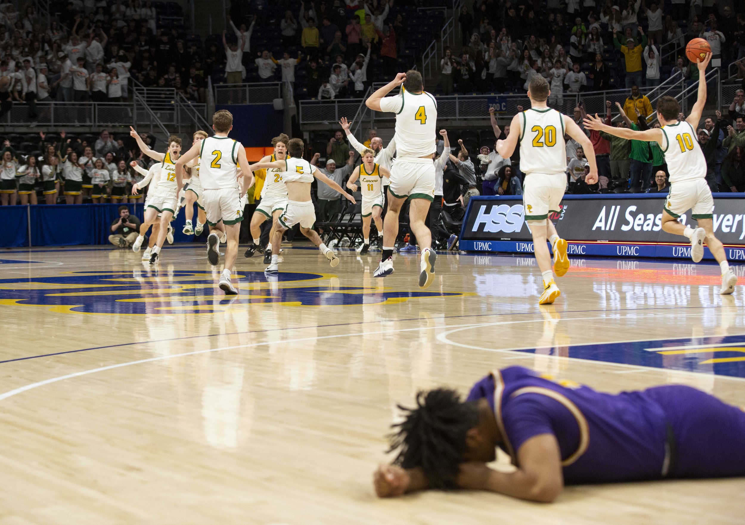  Deer Lakes celebrates their 61-60 victory against OLSH in the WPIAL Class 3A championship on Friday, March 3, 2023, at Petersen Events Center. OLSH's Dereon Greer can be seen laying on the court after the down-to-the-buzzer defeat. (Emily Matthews/P
