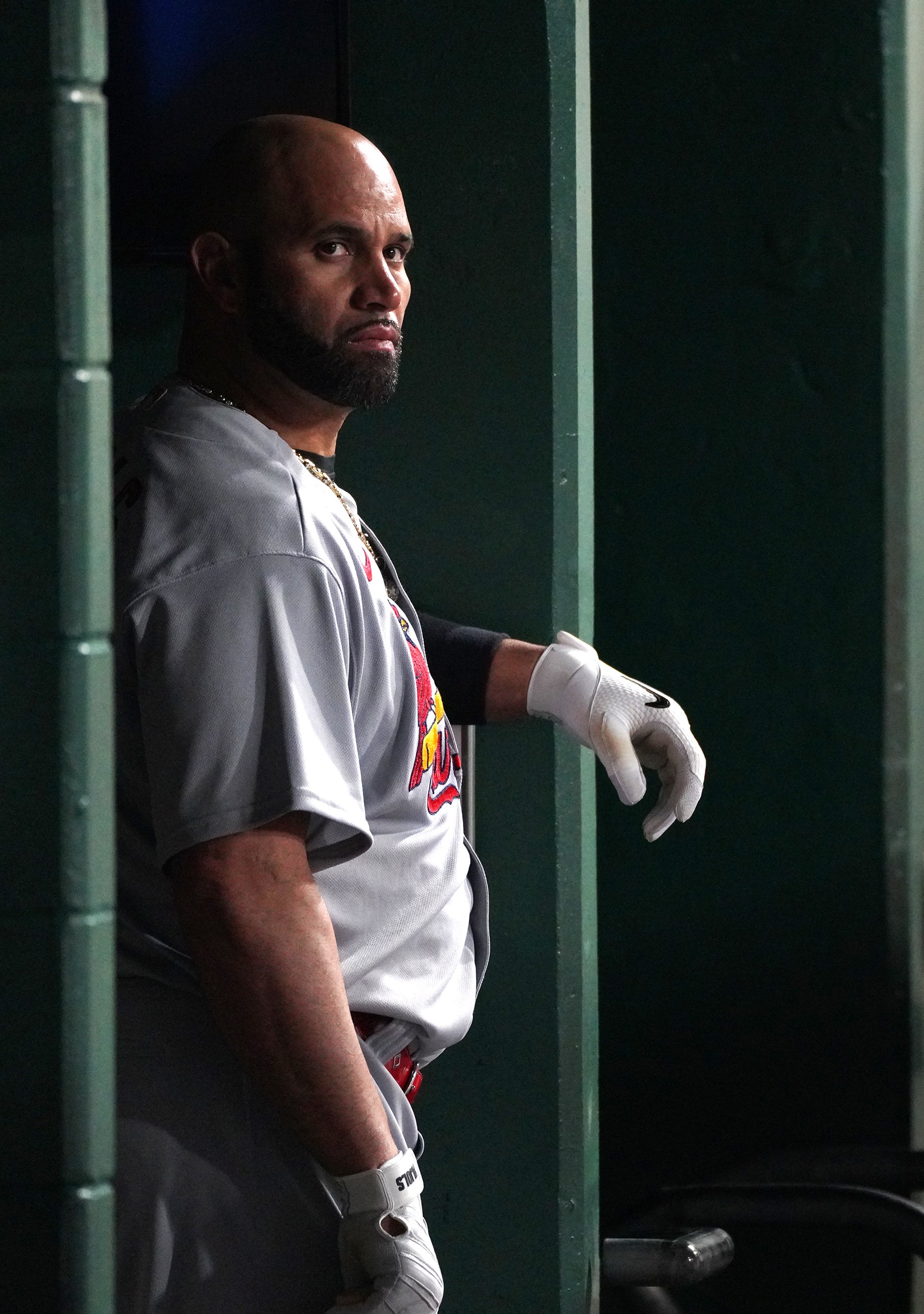  The Cardinals' Albert Pujols stands in the dugout before hitting his 703rd home run and 2,216th RBI, passing Babe Ruth for the second-most RBIs, during his team's game against the Pirates on Monday, October 3, 2022, at PNC Park in Pittsburgh.  (Emil