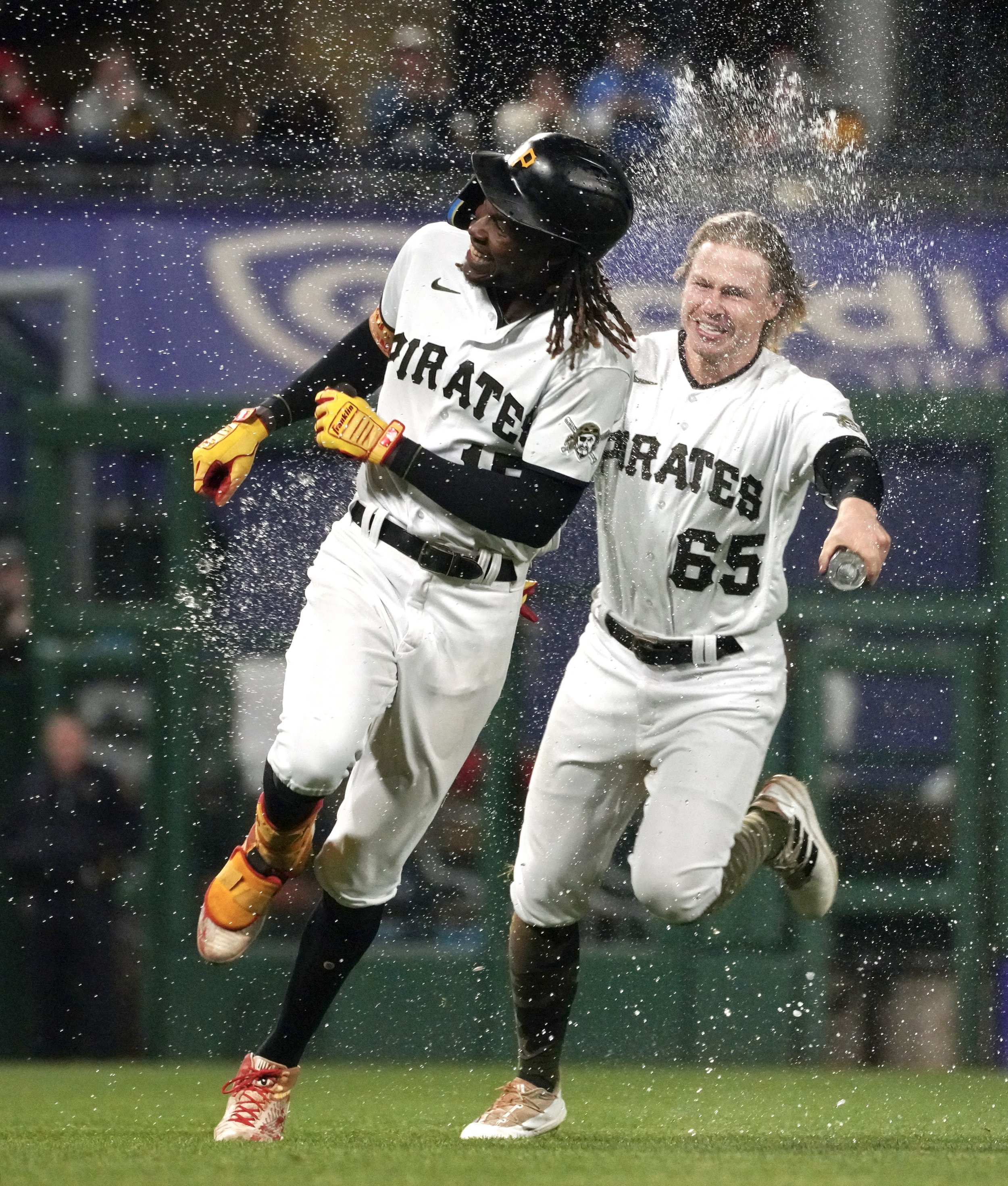  The Pirates' Oneil Cruz runs away from Jack Suwinski as Suwinski sprays him with water after their 3-2 win against the Cardinals on Monday, October 3, 2022, at PNC Park in Pittsburgh. Cruz was walked with bases loaded to end the game. (Emily Matthew