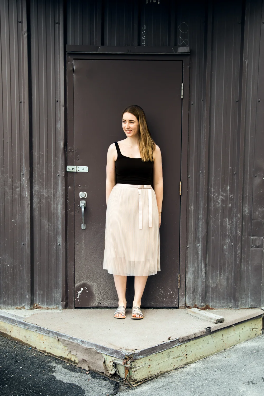 Black Free People tank paired with a nude Darling Roxy Skirt