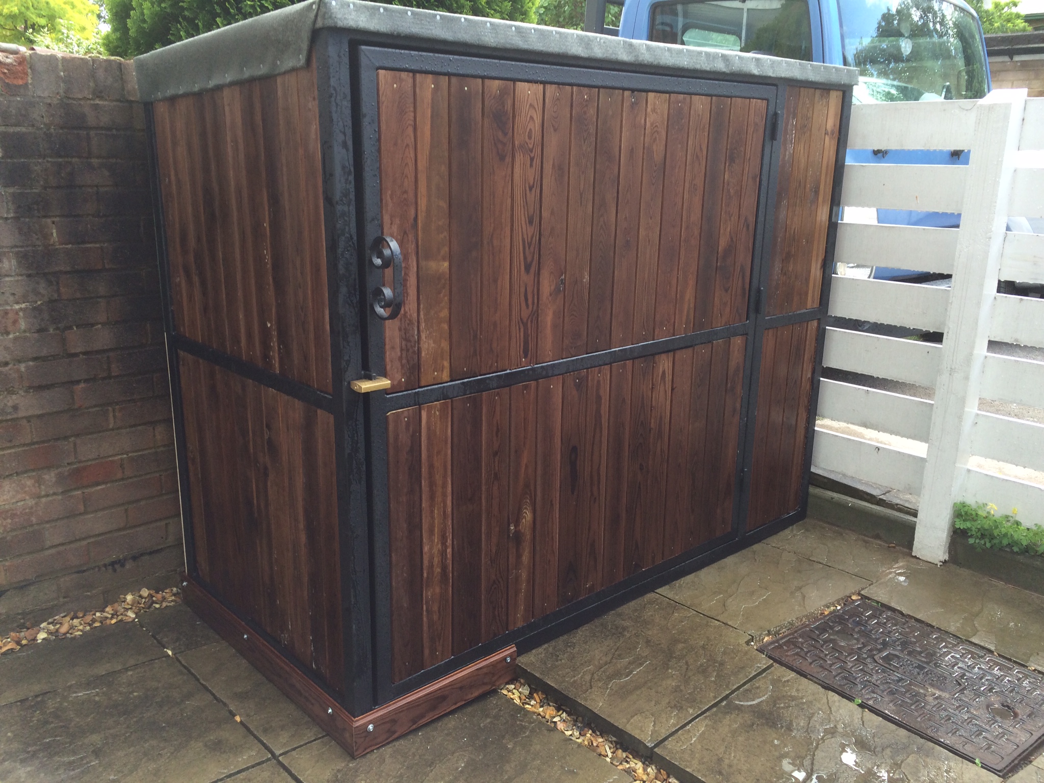  bespoke bicycle shed or garden tool shed using box section steel and brown tongue groove wood 