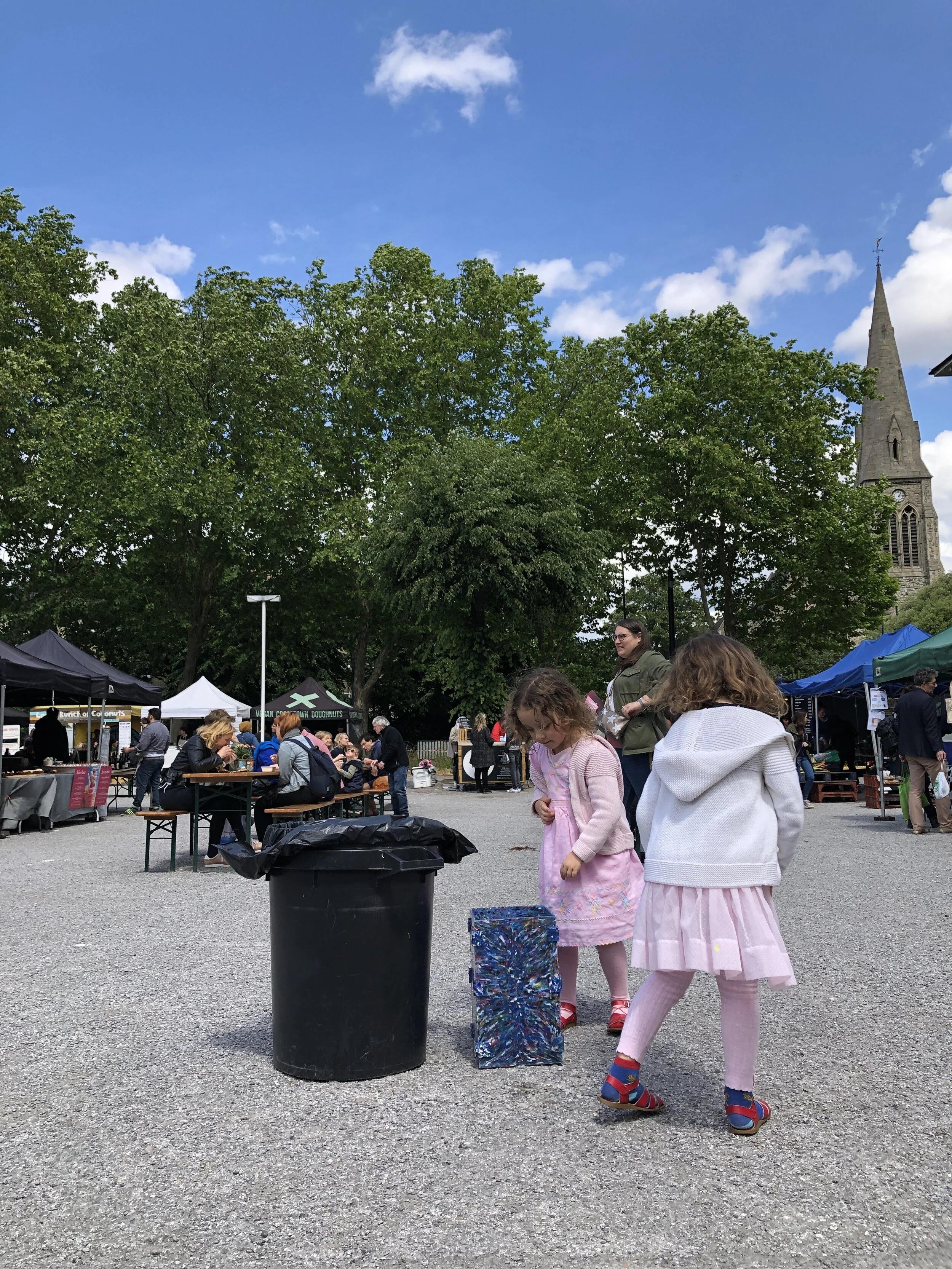 Children disposing of their recyclable waste in the bin, made from waste once found in a bin.