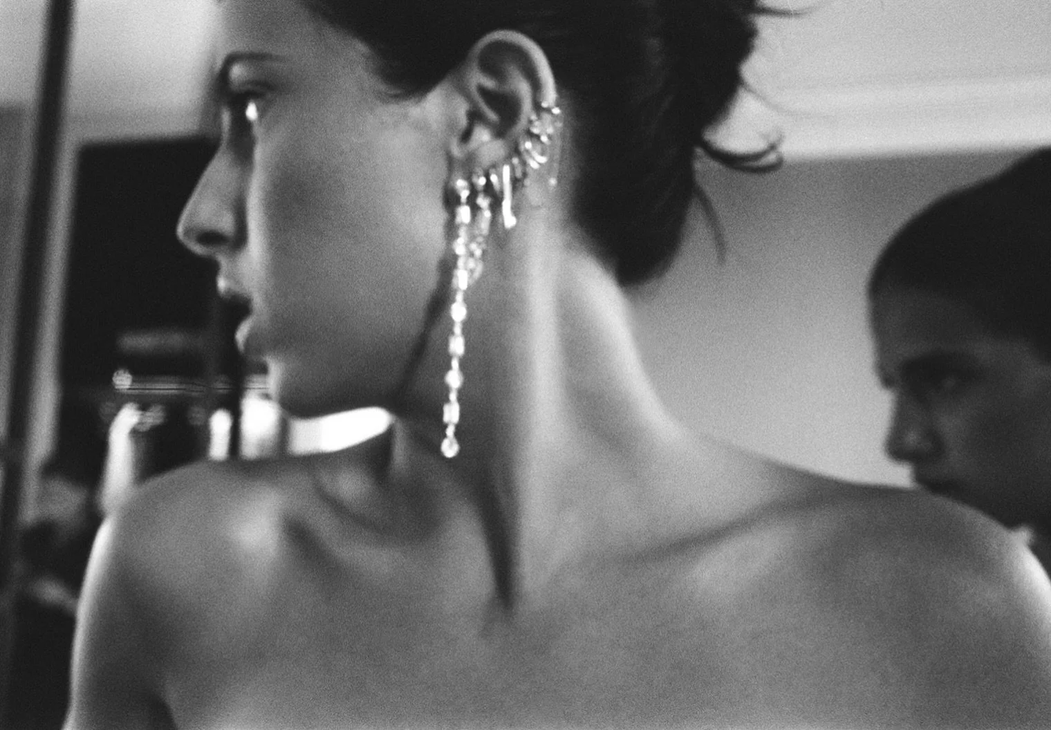 Tara and her sister checking the corset lacing in the mirror. I moved closer to photograph her beautiful ear stack while they were both focused on the reflection.

I love how close to them, yet somehow so far away I feel in this photograph.